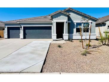 Charming single-story home featuring a two-car garage, desert landscaping, and neutral paint scheme at 12473 E Bahia Ct, Florence, AZ 85132