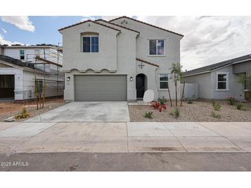 Charming two-story home with a gray stucco exterior, two-car garage, and low-maintenance landscaping at 2557 E Music Mountain Ave, Apache Junction, AZ 85119