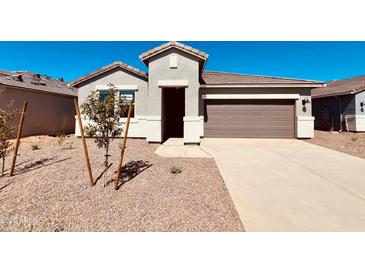 Charming single-story home with a well-maintained front yard, and a two-car garage, perfect for modern living at 30316 N Acacia Dr, Florence, AZ 85132