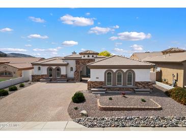 Attractive single-story home showcasing stone accents, a tile roof, and a well-maintained desert landscape at 14112 N 12Th St, Phoenix, AZ 85022
