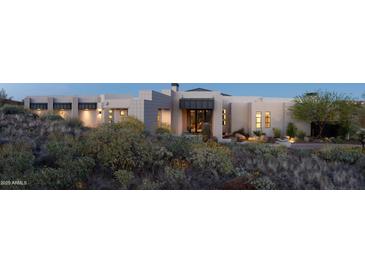 Stunning exterior view of a modern home with desert landscaping at dusk at 15332 E Hidden Springs Trl, Fountain Hills, AZ 85268