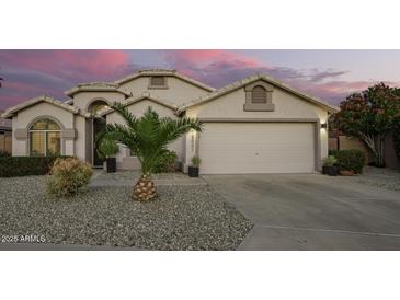 Charming single-story home boasts a well-maintained front yard with desert landscaping and a two-car garage at 18001 N 44Th Way, Phoenix, AZ 85032