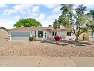 Charming single-story home with a well-maintained front yard and a two-car garage at 332 E Houston Ave, Gilbert, AZ 85234