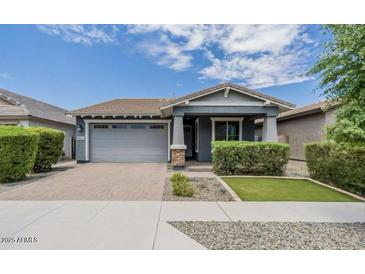 Charming single-story home featuring a well-manicured lawn and an attached two-car garage at 3386 E Strawberry Dr, Gilbert, AZ 85298