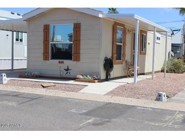 Charming mobile home featuring an inviting covered entryway and easy-to-maintain landscaping at 7807 E Main St # H7, Mesa, AZ 85207