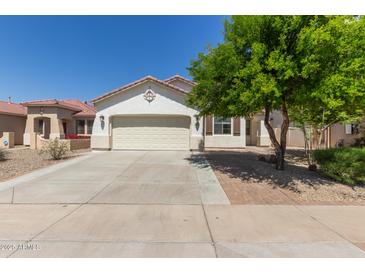 Charming single-story home featuring a well-maintained front yard and a two-car garage at 9518 W Hazelwood St, Phoenix, AZ 85037