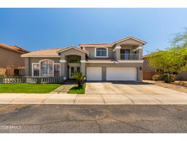 Two-story home with a three-car garage and well-manicured front yard at 13323 W Rancho Dr, Litchfield Park, AZ 85340