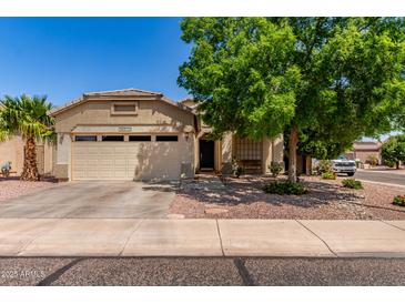 Charming single-story home with a well-manicured front yard and attached two-car garage at 16603 N 168Th Dr, Surprise, AZ 85388