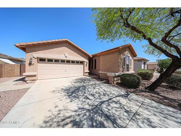 Charming single-story home with a two-car garage and well-maintained landscaping at 17050 W Manchester Dr, Surprise, AZ 85374