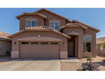 Charming two-story home with a spacious two-car garage and desert landscaping at 19933 N Emmerson Dr, Maricopa, AZ 85138