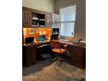 Well lit office space with wooden built-ins and space for working from home at 20230 N Jill Ave, Maricopa, AZ 85138