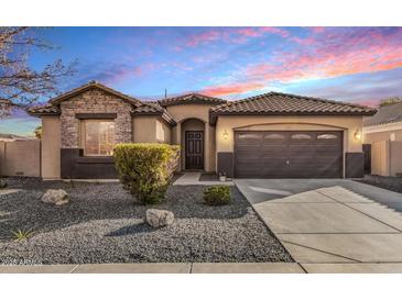 Charming single-story home featuring stone accents, a tile roof, and a two-car garage at 2329 E Ebony Dr, Chandler, AZ 85286