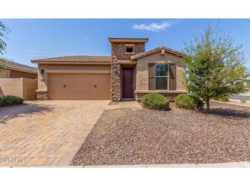 Charming single-story home featuring a stone facade, two-car garage, and desert landscaping for low maintenance at 296 N Jesse St, Chandler, AZ 85225