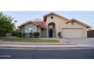 Charming single-story home with a well-maintained front yard and a neutral color scheme at 441 E Encinas Ave, Gilbert, AZ 85234
