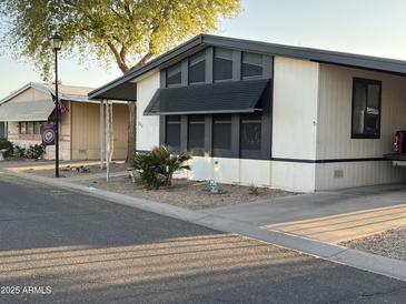 Charming home featuring desert landscaping and a covered parking area at 6960 W Peoria Ave # 212, Peoria, AZ 85345