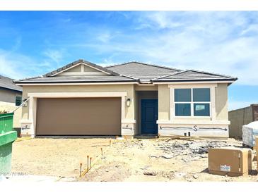 Single-Gathering home showing a two-car garage, neutral color palette, and desert landscaping at 8394 W Clemente Way, Florence, AZ 85132
