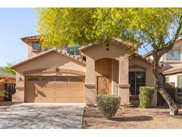 Charming two-story home featuring an attached two-car garage and a welcoming front porch at 15432 W Yucatan Dr, Surprise, AZ 85379
