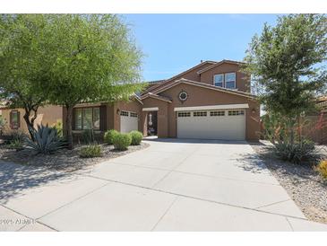 Charming two-story home features a concrete driveway and manicured desert landscaping at 17981 W Agave Rd, Goodyear, AZ 85338
