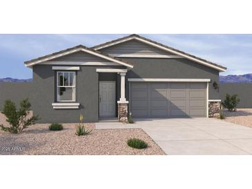 Charming single-story home with a gray facade, desert landscaping, and a two-car garage at 18256 W La Senda Dr, Surprise, AZ 85387