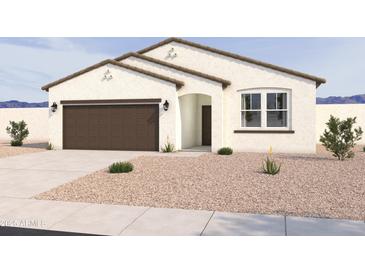 Charming single-story home boasts a well-manicured desert landscaped front yard and a two-car garage at 18261 W Camino De Oro --, Surprise, AZ 85387