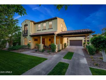 Charming two-story home with a tile roof, covered porch, and beautifully landscaped front yard at 20791 W Main St, Buckeye, AZ 85396
