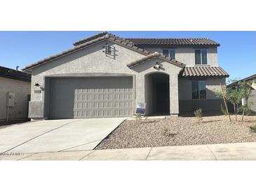 Charming two-story home featuring a neutral color scheme, landscaped front yard, and a two-car garage at 25348 W Bowker St, Buckeye, AZ 85326