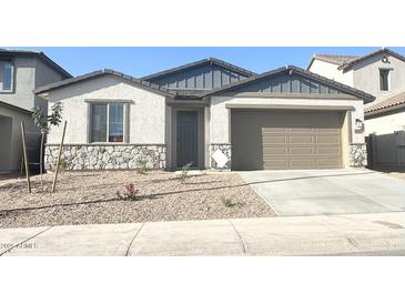 Charming single story home featuring stone accents and a neutral color palette for a modern and inviting curb appeal at 25354 W Bowker St, Buckeye, AZ 85326