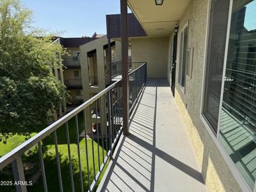 Outdoor balcony with view of the green lawn and apartments at 461 W Holmes Ave # 336, Mesa, AZ 85210