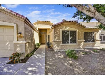 Inviting single-story home exterior with desert landscaping and a covered entrance, offering curb appeal at 7332 W Pershing Ave, Peoria, AZ 85381