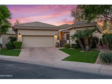 Charming single-story home featuring a neutral color palette, desert landscaping, and a spacious two-car garage at 7425 E Gainey Ranch Rd # 13, Scottsdale, AZ 85258