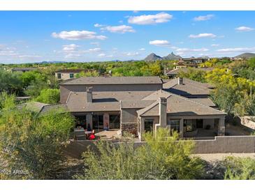 Luxury home featuring a tile roof, desert landscaping, mountain views, and a private outdoor living space at 9280 E Thompson Peak Pkwy # 39, Scottsdale, AZ 85255