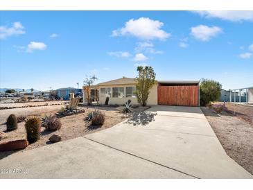 Charming single-story home featuring xeriscaping, a concrete driveway, and a cozy exterior at 9347 E Edgewood Ave, Mesa, AZ 85208