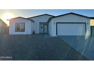 Inviting single-story home showcasing a clean white facade, black trim, and a well-kept gravel front yard at 15864 S Cherry Hills Dr, Arizona City, AZ 85123