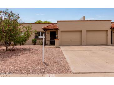 Charming single-story home with a two-car garage and well-maintained landscaping at 4501 E Carol Ave # 48, Mesa, AZ 85206
