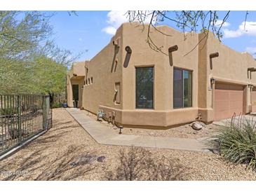 Exterior view of the home showcasing its southwestern architecture and desert landscaping at 6088 E Knolls N Way, Cave Creek, AZ 85331