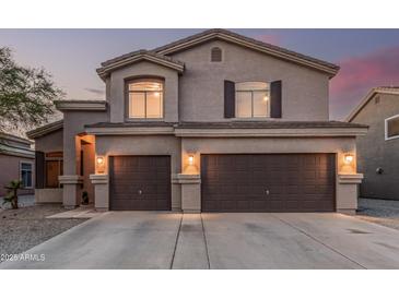 Inviting two-story home featuring a neutral color palette and a spacious two-car garage for convenient parking and storage at 12376 W Hazelwood St, Avondale, AZ 85392