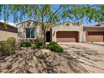 Charming home featuring a desert landscaped yard, covered entry, and two-car garage at 16946 W Vernon Ave, Goodyear, AZ 85395