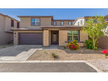 Charming two-story home featuring a two-car garage and landscaped front yard with stone accents at 17736 W Cassia Way, Goodyear, AZ 85338