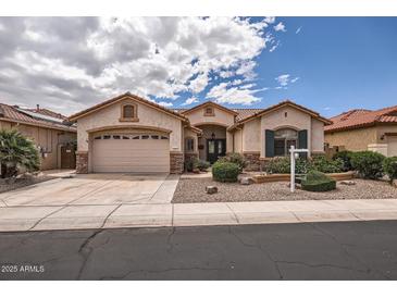 Beautiful single-Gathering home featuring a three-car garage and manicured desert landscaping at 17951 W Sammy Way, Surprise, AZ 85374