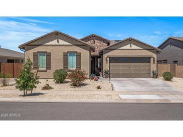 Charming single-story home featuring a stone facade, desert landscaping, and a two-car garage at 18970 W Desert Hills Dr, Surprise, AZ 85388