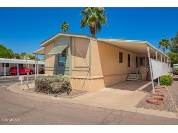 Charming home with covered parking, mature landscaping and desirable curb appeal at 201 S Greenfield Rd # 129, Mesa, AZ 85206