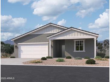 Inviting single-story home showcasing a clean landscape, a two-car garage and charming architectural details at 24072 W Bowker St, Buckeye, AZ 85326
