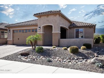 Charming home featuring desert landscaping with a tile roof and covered entryway at 26421 W Zachary Dr, Buckeye, AZ 85396