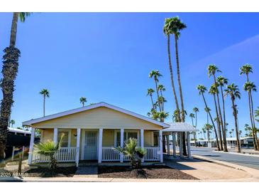 Charming single-story home featuring a covered carport, well-maintained yard, and mature palm trees at 7300 N 51St Ave # A259, Glendale, AZ 85301