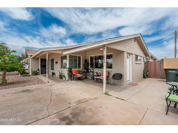 Welcoming covered front porch with cozy seating, perfect for relaxing outdoors at 1934 W Colter St, Phoenix, AZ 85015