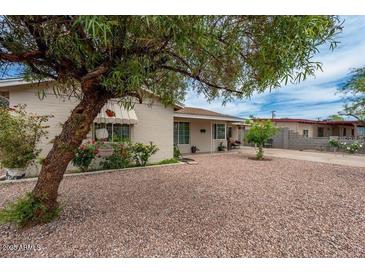 Inviting single-story home with desert landscaping and mature shade tree at 1934 W Colter St, Phoenix, AZ 85015