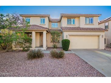 Charming two-story home featuring a well-manicured lawn and a spacious two-car garage at 21672 N Geraldine Dr, Peoria, AZ 85382
