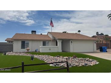 Charming single-story home with unique landscaping featuring green turf and decorative rocks at 4621 E Mineral Rd, Phoenix, AZ 85044