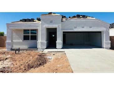 Charming single-story home with a two-car garage, a modern design, and tile roofing in progress at 5064 E Midnight Star Dr, San Tan Valley, AZ 85143