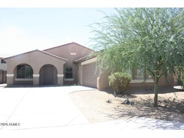Charming single-story home featuring a stucco exterior, arched entryway, and easy to maintain desert landscaping at 8009 S 53Rd Ave, Laveen, AZ 85339